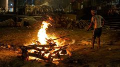 The Doms, a group belonging to a Hindu caste, earn their living by running the cremation pyres and maintaining the source fire that is used to light all of the pyres.