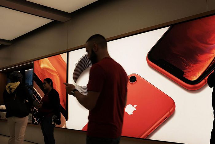People stand in an Apple store in Manhattan.