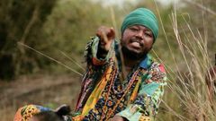 Blakk Rasta dressed in an African print