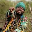 Blakk Rasta dressed in an African print