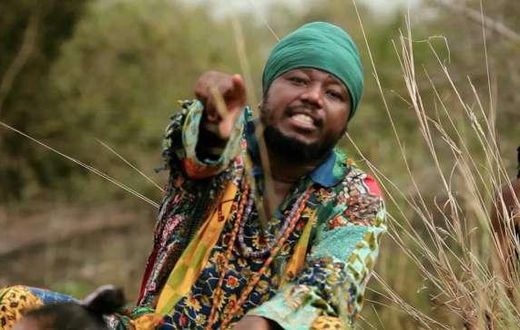 Blakk Rasta dressed in an African print