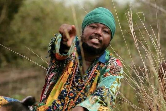 Blakk Rasta dressed in an African print