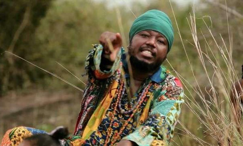 Blakk Rasta dressed in an African print