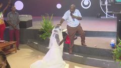 Pastor Serwadda praying for the woman