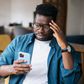 A man looking at his phone worried