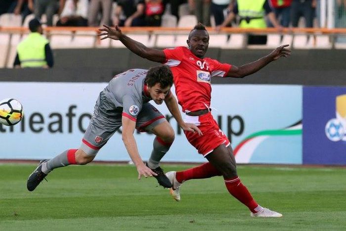 Perspolis' Godwin Mensha (right) in action in Tehran, he is one of the stalwarts of the Iranian giants' campaign