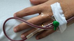 A stock image of a person receiving a blood transfusion. People with hemophilia B receive regular infusions of clotting factor IX to treat their condition.