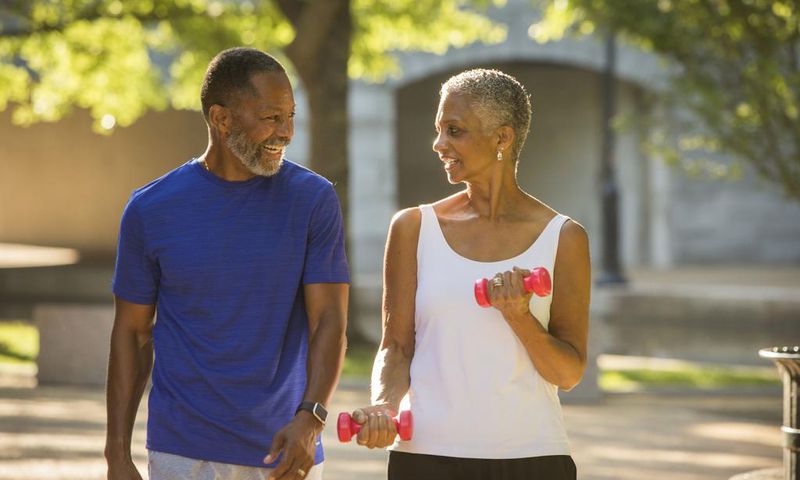 Black couple walking in park