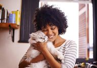 A woman having a good time with a cat