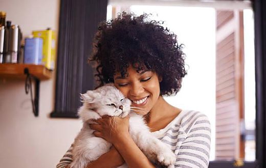 A woman having a good time with a cat