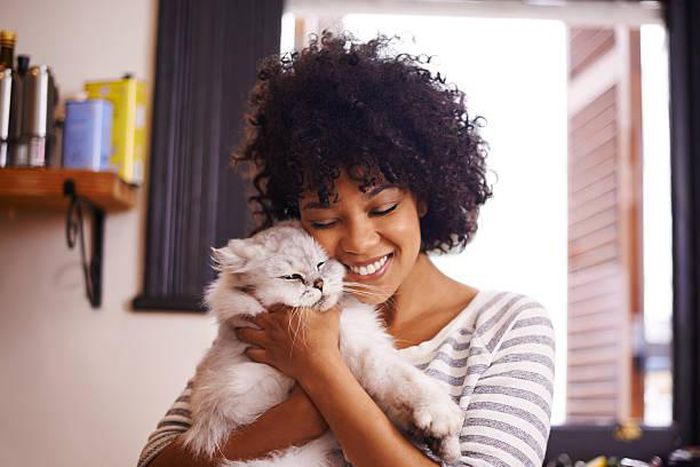 A woman having a good time with a cat