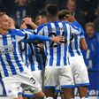 Huddersfield players celebrate after taking the lead against Fulham