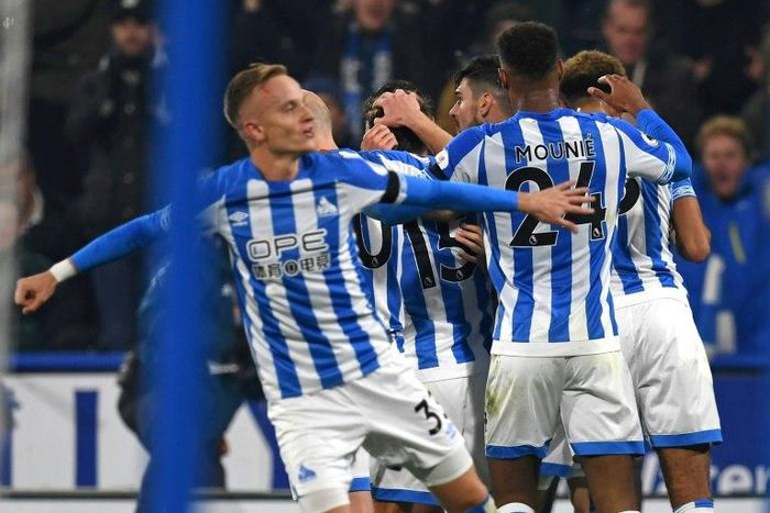 Huddersfield players celebrate after taking the lead against Fulham