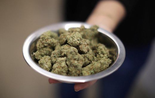 A woman holds marijuana for sale at the MedMen store in West Hollywood. REUTERS/Lucy Nicholson