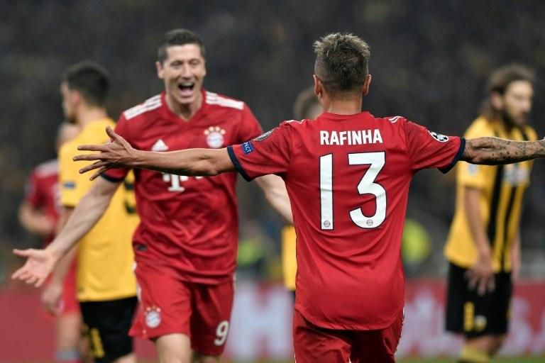 Bayern Munich defender Rafinha congratulates Poland striker Robert Lewandowski for scoring their second goal at AEK on Tuesday.
