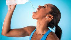 Sports woman drinking water
