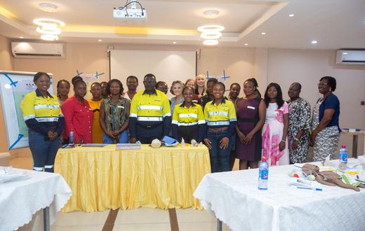 Newmont and Project C.U.R.E officials with health professionals.