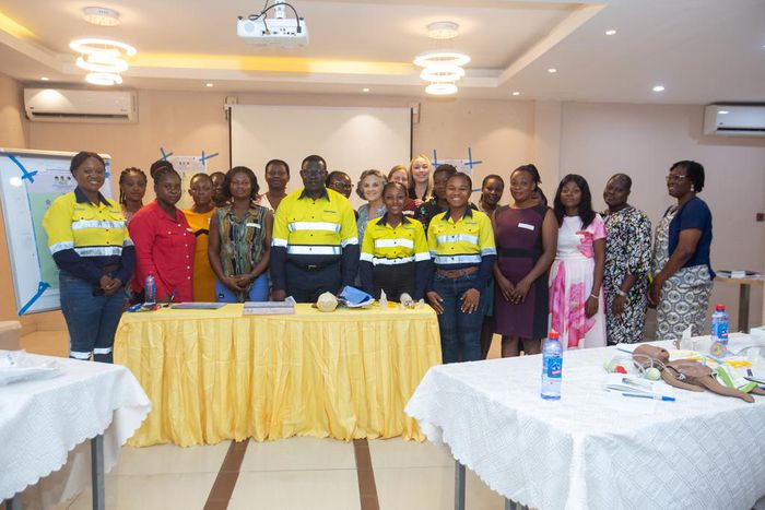 Newmont and Project C.U.R.E officials with health professionals.