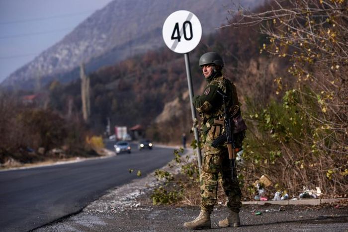 A soldier of the NATO-led peacekeeping mission in Kosovo (KFOR) secures the area near the village of Rudare in northern Mitrovica during a protest of Kosovo Serbs on November 23, 2018
