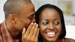 Man whispering to woman's ear(citinewsroom)