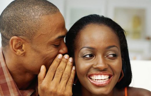 Man whispering to woman's ear(citinewsroom)