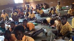 Pupils sit on bare floor (File photo)