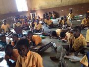 Pupils sit on bare floor (File photo)