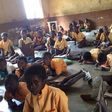 Pupils sit on bare floor (File photo)