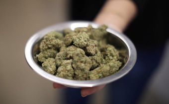 A woman holds marijuana for sale at the MedMen store in West Hollywood. REUTERS/Lucy Nicholson