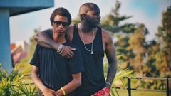 A father and his teenage son posing on a balcony [Photo: Kaysha]