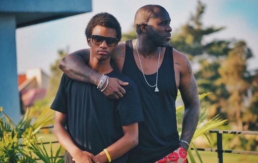 A father and his teenage son posing on a balcony [Photo: Kaysha]