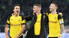 Borussia Dortmund midfielders Thomas Delaney (L), Jacob Bruun Larsen (C) and Marco Reus (R) celebrate Saturday's 1-0 win at Wolfsburg - a new club record of 15 games unbeaten - ahead of Tuesday's tough Champions League game away to Atletico Madrid.