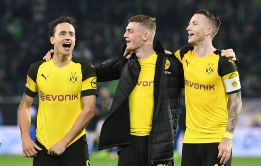 Borussia Dortmund midfielders Thomas Delaney (L), Jacob Bruun Larsen (C) and Marco Reus (R) celebrate Saturday's 1-0 win at Wolfsburg - a new club record of 15 games unbeaten - ahead of Tuesday's tough Champions League game away to Atletico Madrid.