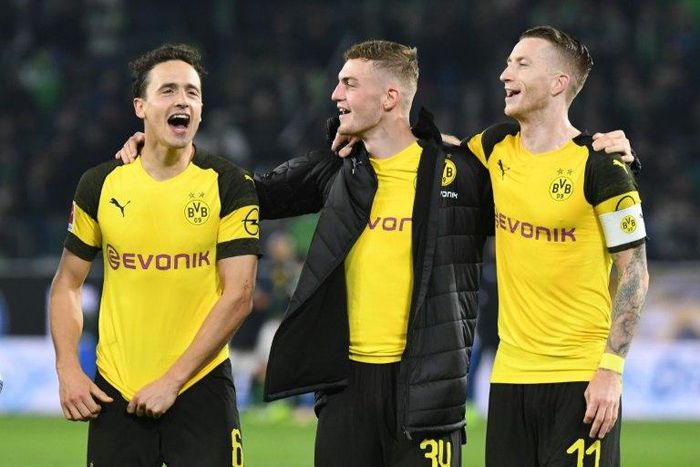 Borussia Dortmund midfielders Thomas Delaney (L), Jacob Bruun Larsen (C) and Marco Reus (R) celebrate Saturday's 1-0 win at Wolfsburg - a new club record of 15 games unbeaten - ahead of Tuesday's tough Champions League game away to Atletico Madrid.