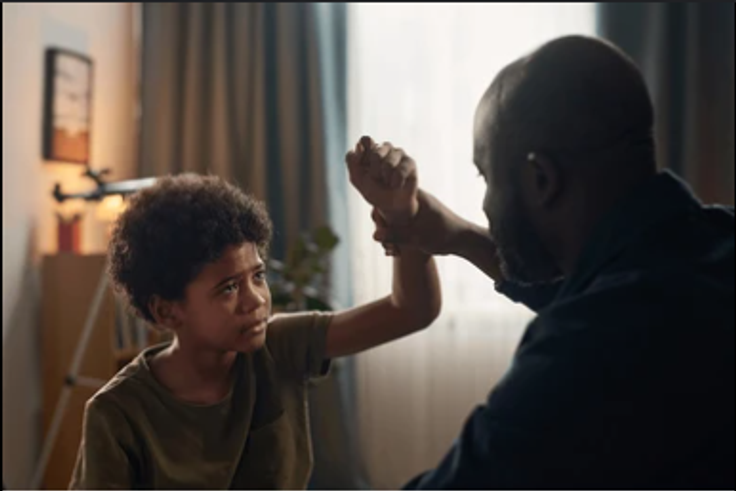 Father beating son [Shutterstock]
