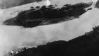 Believed to be the first bomb dropped on Pearl Harbor, Hawaii in the sneak-attack on Dec. 7, 1941, this picture was found torn to pieces at Yokusuka Base by photographer's mate 2/C Martin J. Shemanski of Plymouth, Pa. One Japanese plane is shown pullin...