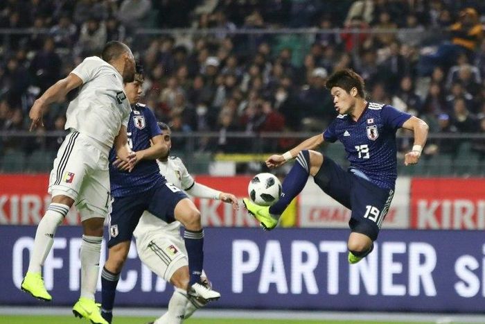 Japan's defender Hiroki Sakai (R) scored a 39-minute opener, his first goal for the national team on his 49th international