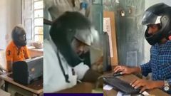 Workers wear motorcycle helmets due to falling debris from dilapidated office