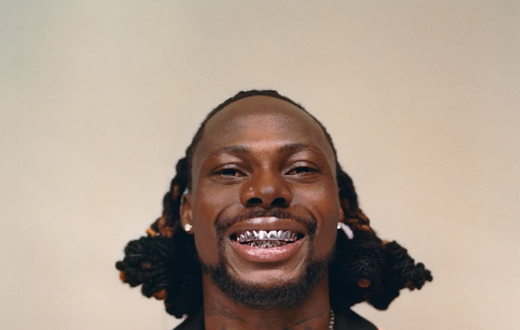 Asake has an unmistakable tattoo of his name on his neck [GQ Magazine]