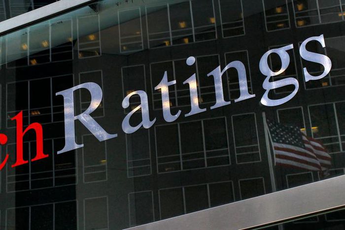 A flag is reflected on the window of the Fitch Ratings headquarters in New York in this, February 6, 2013.