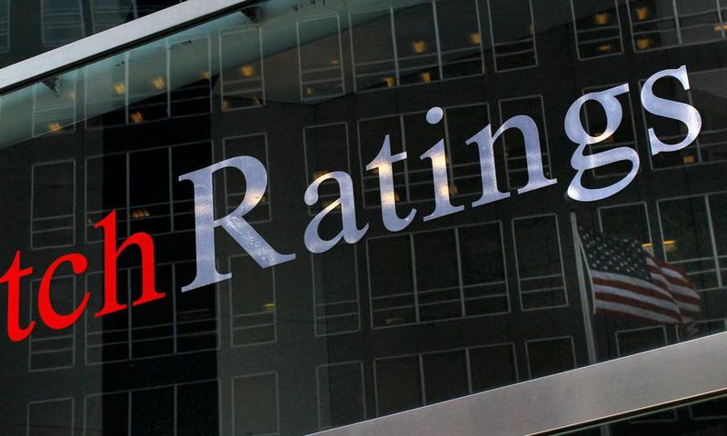 A flag is reflected on the window of the Fitch Ratings headquarters in New York in this, February 6, 2013.