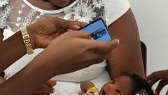 A baby is screened during a trial in a large-scale feasibility study using a smartphone-based screening for jaundice at Greater Accra Regional Hospital in Accra, Ghana in this undated handout photo from the University of Ghana