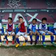 Children rest after a training session at the Guangzhou R&F Football Academy in Meizhou in southern China