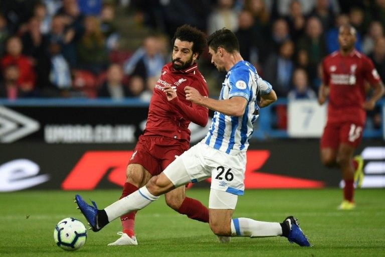 Mohamed Salah shooting beyond the attempted block of Christopher Schindler as he scores the only goal in Liverpool's 1-0 win away to Huddersfield