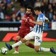 Mohamed Salah shooting beyond the attempted block of Christopher Schindler as he scores the only goal in Liverpool's 1-0 win away to Huddersfield