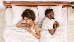 Frustrated Black couple in bed [iStock]
