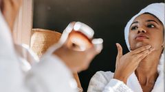 Black woman in front of a mirror [Daily Vanity]