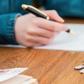 A stock photo shows a person signing a mortgage contract.Getty Images