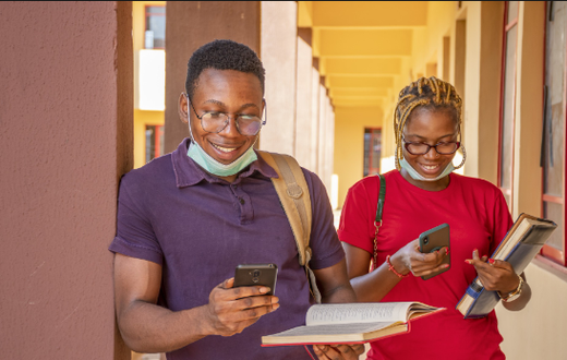 Students pressing their phones [Techpoint Africa]