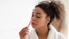 Lady shaving her face